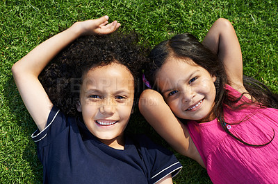 Buy stock photo Cropped shot of a smiling brother and sister lying on the grass
