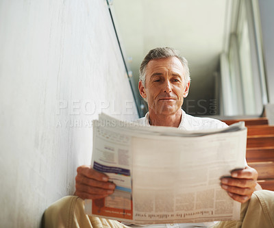 Buy stock photo Mature, man and newspaper reading in office for stock market review for news article, journalist or investment. Male person, face and business section on stairs with global financial, report or press