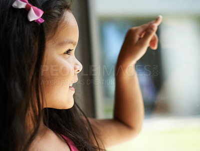 Buy stock photo A cute little girl looking away and pointing