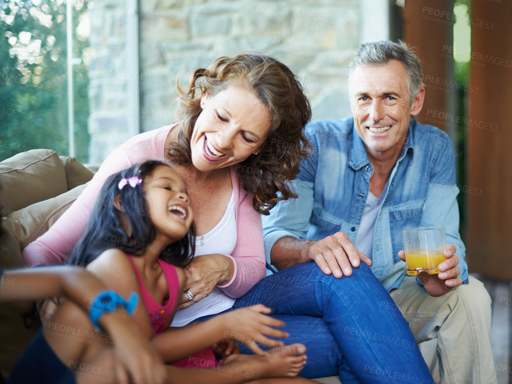 Buy stock photo Laughter, bonding and happy family on the sofa for conversation, love or talking. Smile, house and grandmother, grandfather and child on couch for comfort, care and joke together in home lounge