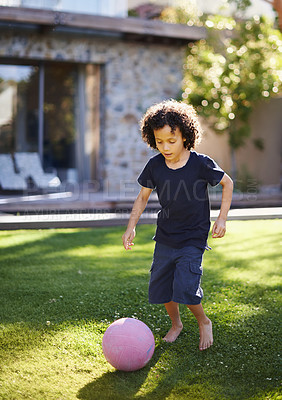 Buy stock photo Boy, playing and ball in outside garden for fun, recreational and sport for growth and childhood development with kid. Exercise, wellness and football practice or game on grass, backyard and home