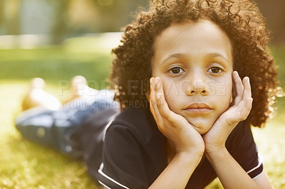 Buy stock photo Portrait, sunshine and child on grass, bored and nature for fun, weekend break and holiday. Face, outdoor and kid in garden, relax and summer with rest, casual and vacation with youth in countryside