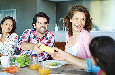 Buy stock photo A happy family eating together at home
