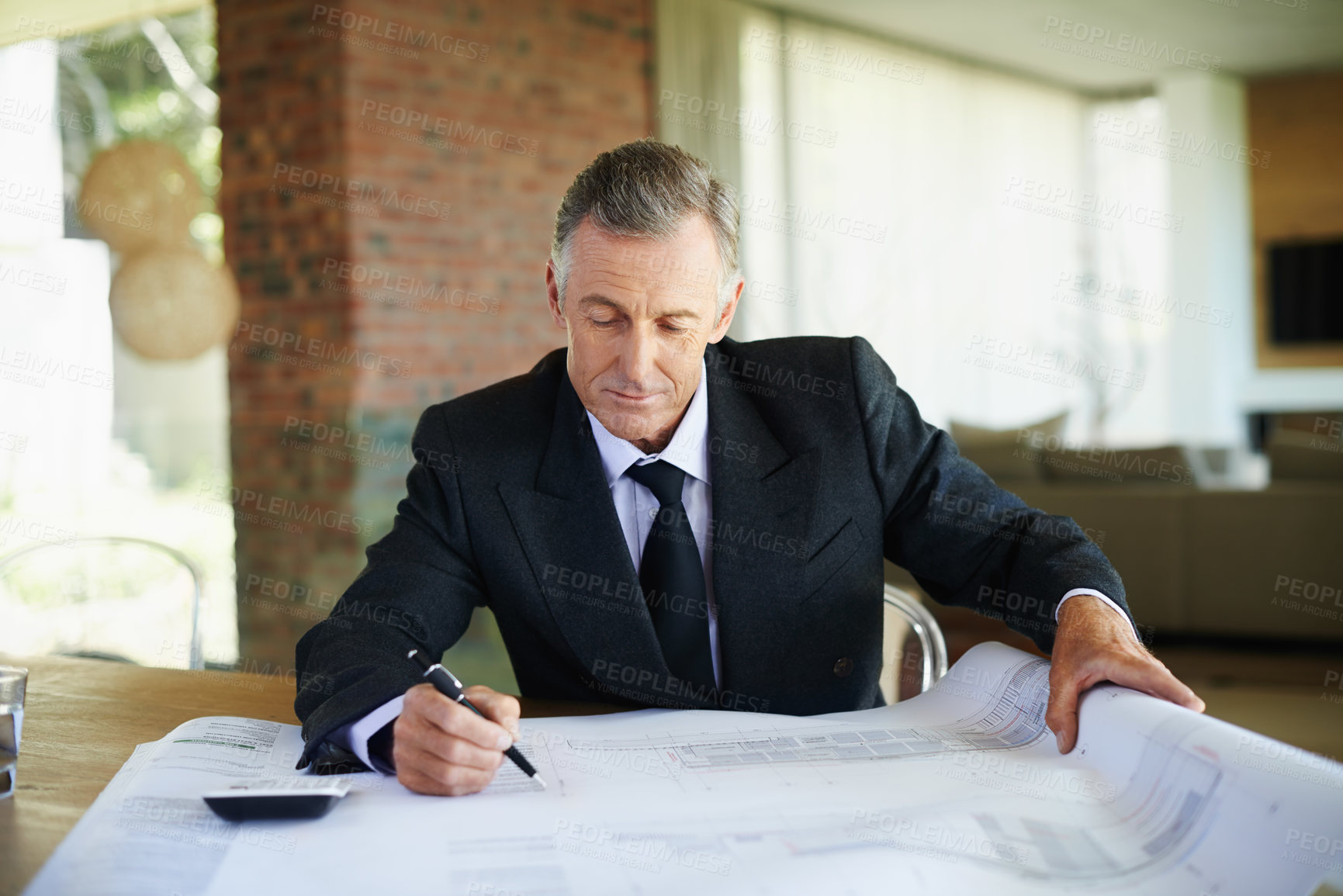 Buy stock photo Suit, blueprint and mature man in office, finance and calculator for tax of investment in property. Real estate, realtor and executive of business with floor plan and paperwork for budget on desk