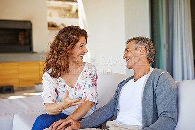Buy stock photo Laughing, happy or mature couple in home living room for conversation or communication in marriage. Smile, talking or funny woman speaking of joke to man in retirement or discussion to relax together