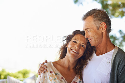 Buy stock photo Portrait of an affectionate mature happy couple hugging in a hotel lounge enjoying a romantic date during summer. Loving husband and charming wife bonding and smiling during their anniversary 