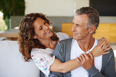 Buy stock photo Mature couple, happy and embrace on couch in living room with love, commitment and care. Elderly partners, hug and smile at home with security, compassion and happy together in house or apartment