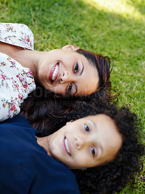 Buy stock photo Face, mom and child lying on grass in garden to relax in summer, vacation or picnic in holiday. Family, happiness and portrait of mother with kid on lawn in backyard and smile together from above