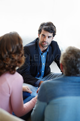 Buy stock photo A young consultant giving advice to a mature couple