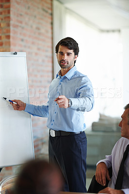 Buy stock photo Meeting, presentation and business man with whiteboard in office for company growth, budget or strategy. Professional, report and person pointing for profit, training or progress at Investment firm