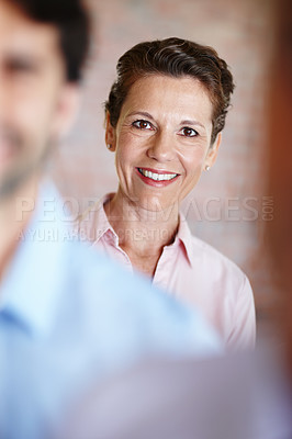 Buy stock photo A confident businesswoman smiles as she embarks on a project with her fellow colleagues