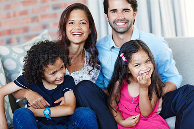 Buy stock photo A fun loving family sitting on the couch together