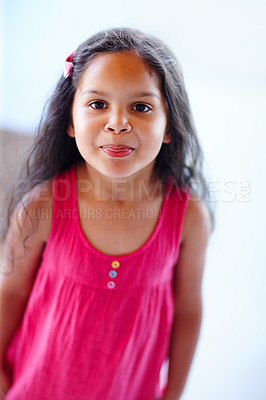 Buy stock photo A little girl sticking her tongue out at the camera
