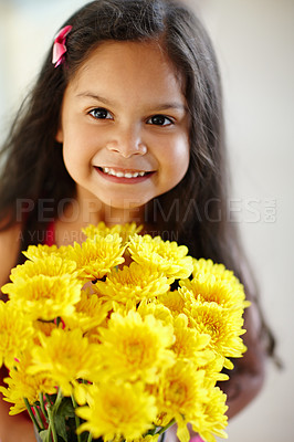 Buy stock photo Portrait of adorable little girl holding bouquet of chrysanthemums at home. One cute child standing alone with bunch of bright yellow flowers for mothers day. Happy smiling child with sweet gesture