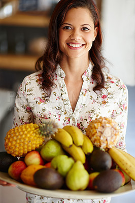 Buy stock photo An attractive woman holding a bowl of fruit