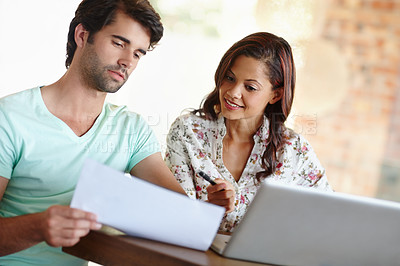 Buy stock photo A young couple discussing their financial situation