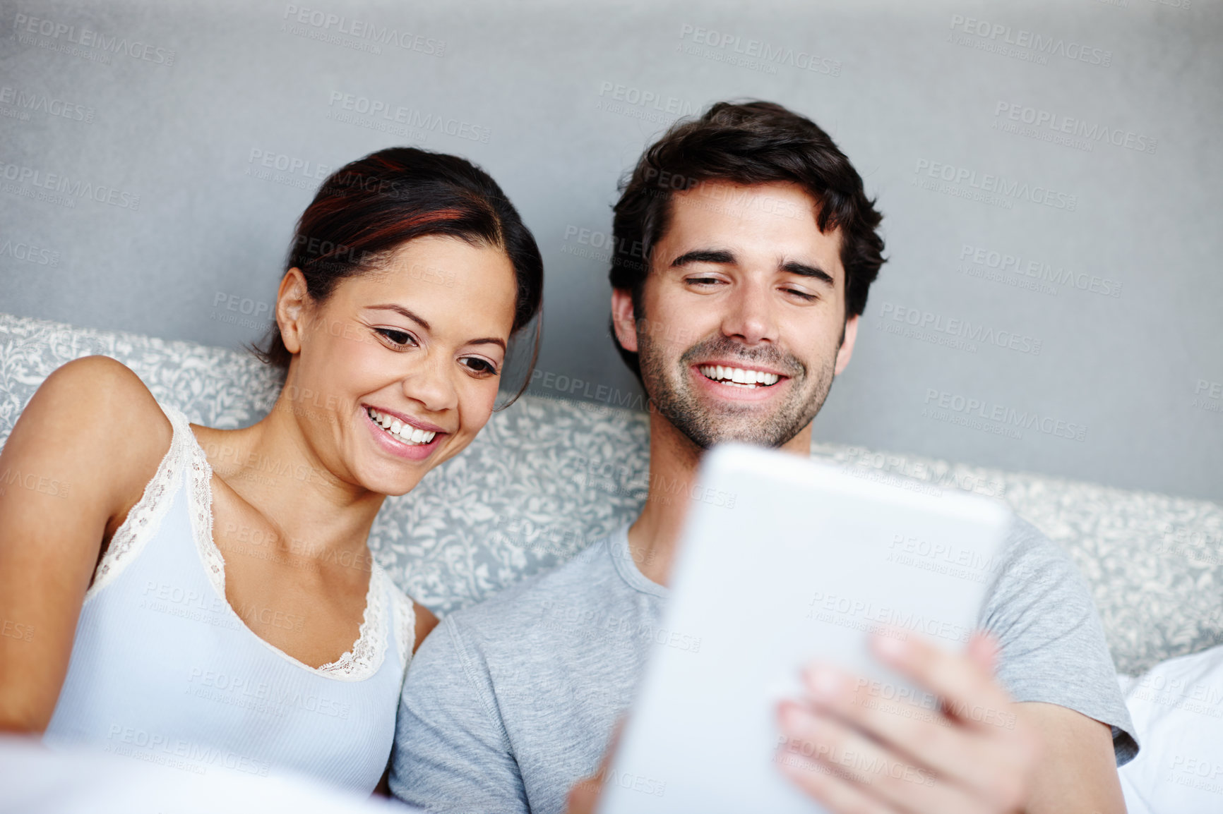 Buy stock photo Happy couple, relax and streaming with tablet on bed for online subscription, watching or connectivity at home. Man, woman and smile on technology for show, movie or browsing in bedroom at house