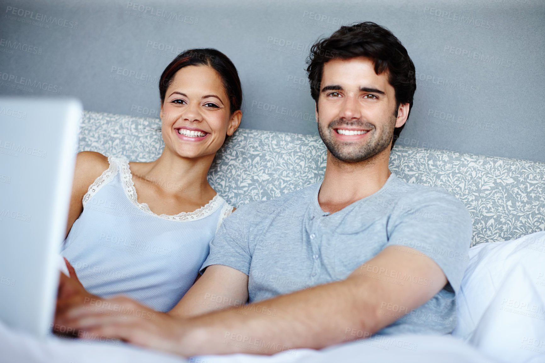 Buy stock photo Laptop, portrait and smile with couple in bed to relax on weekend together for bonding or time off. Computer, streaming or subscription with man and woman in bedroom of home for video entertainment