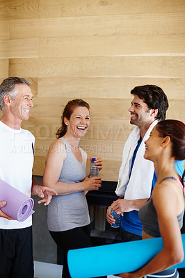 Buy stock photo Young couple and mature couple in sportswear talking to each other