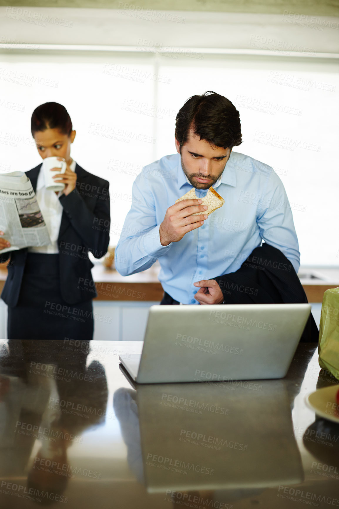 Buy stock photo Home, breakfast and businessman reading of laptop, bread and woman with newspaper for update of stock market. Surprise, employee and auditor with email of report, analytics and rush for project