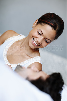 Buy stock photo Couple, happy and lying in bed together talking with love for communication, romance or relationship. Smiling, woman and man cuddle in morning for conversation, discussion and intimate laugh