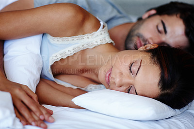 Buy stock photo Sleep, woman and man in bed with love, peace and relax together with comfort in home. Calm, dream and tired couple in bedroom on weekend morning with health, wellness and holding hands in apartment