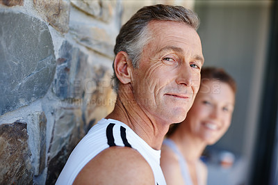 Buy stock photo Fitness, portrait and smile with mature couple outdoor on brick wall for running or training together. Exercise, cardio and face of man with woman at start of daily workout routine to improve health