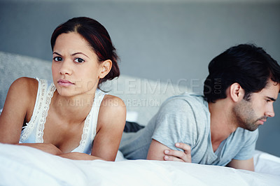 Buy stock photo Portrait of an unhappy couple lying on their bed