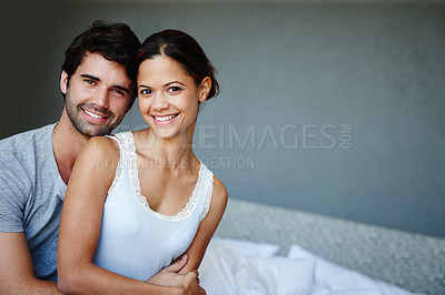 Buy stock photo Portrait of a happy couple sitting on their bed with copyspace