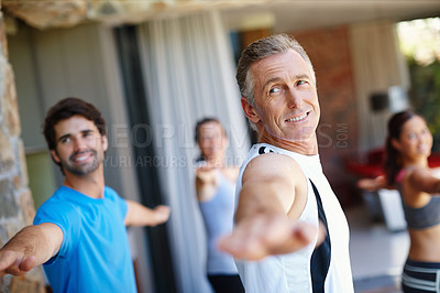 Buy stock photo Mature man, pose and happy in yoga class for fitness and mental wellbeing, workout and daily lesson to coach people. Male yogini, warrior posture and yogis or students practice strength and balance.