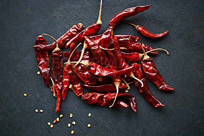 Buy stock photo High angle shot of dried red chillies on a kitchen counter