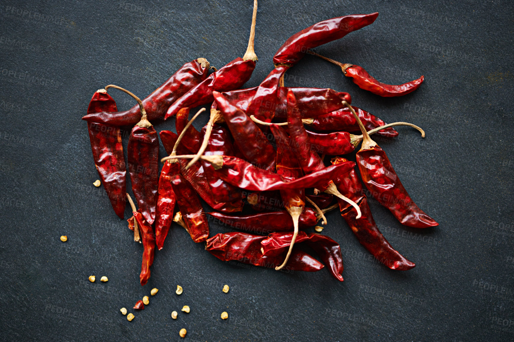 Buy stock photo High angle shot of dried red chillies on a kitchen counter