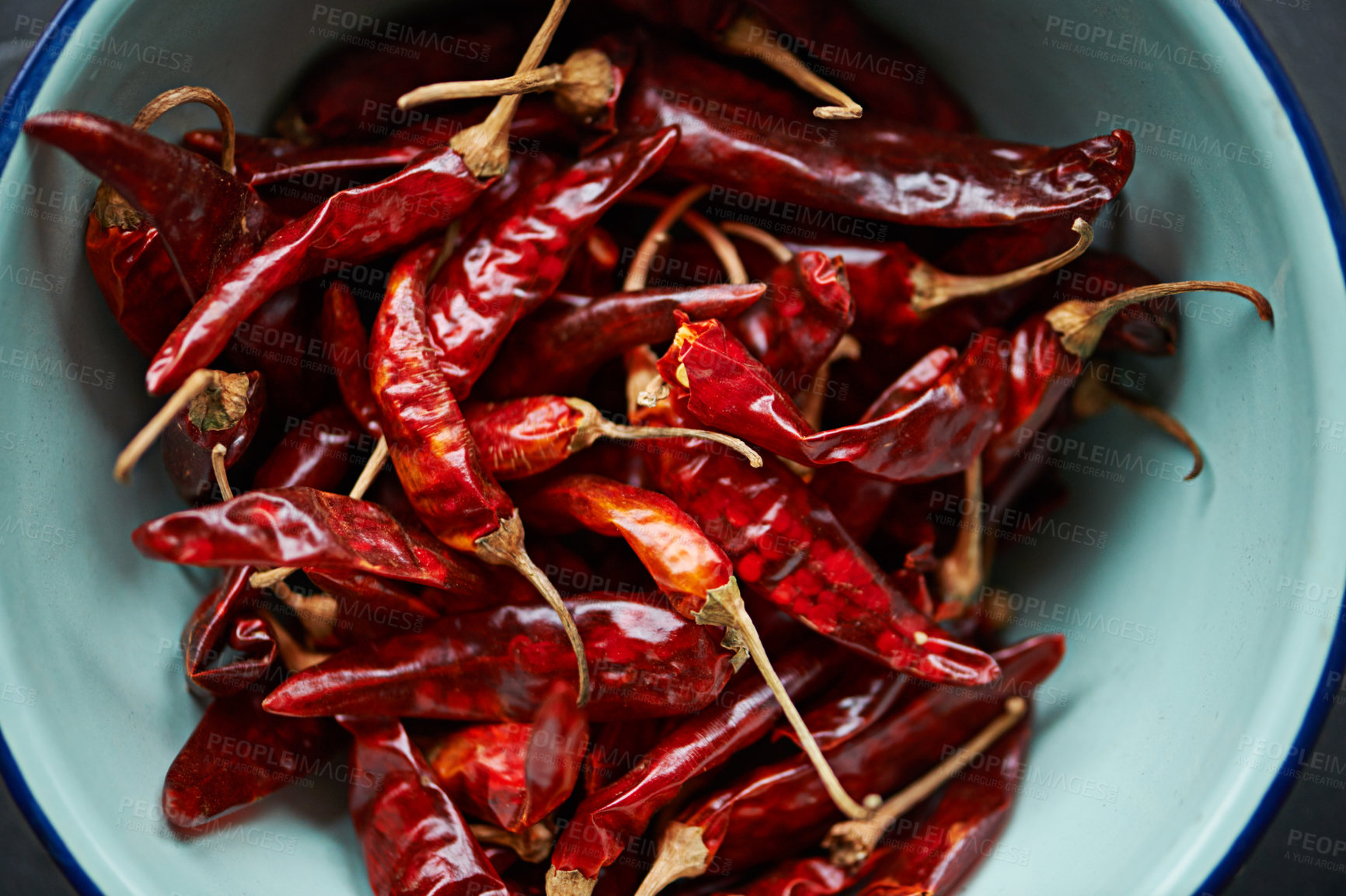 Buy stock photo Above, chilli and bowl on closeup for pepper or spice for flavor and dry ingredient for cooking, cuisine and food. Paprika, cayenne or condiment or spicy with red for capsicum or heat in dish or meal