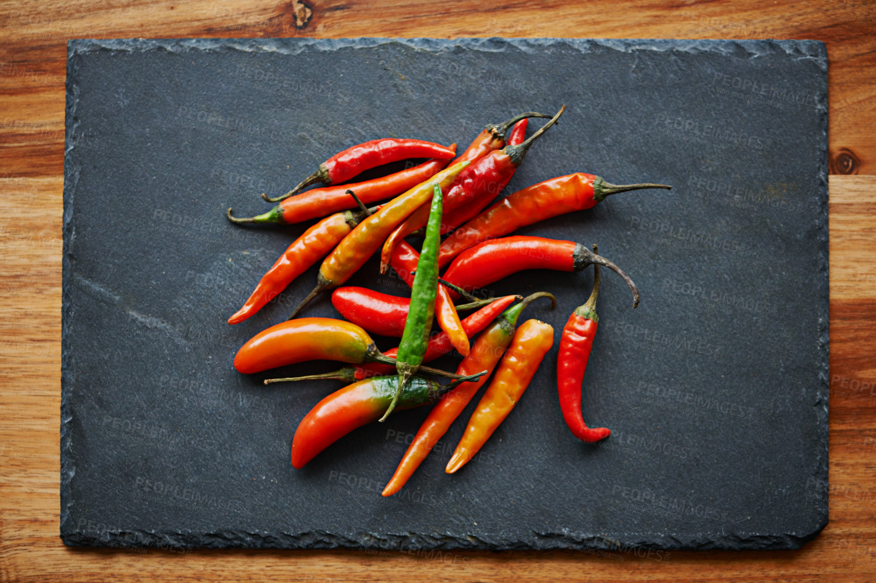 Buy stock photo Above, chilli and kitchen counter for capsicum, spices and flavor for dry ingredient in cooking, cuisine and food. Paprika, cayenne or condiment and spicy with red for pepper or heat in dish or meal