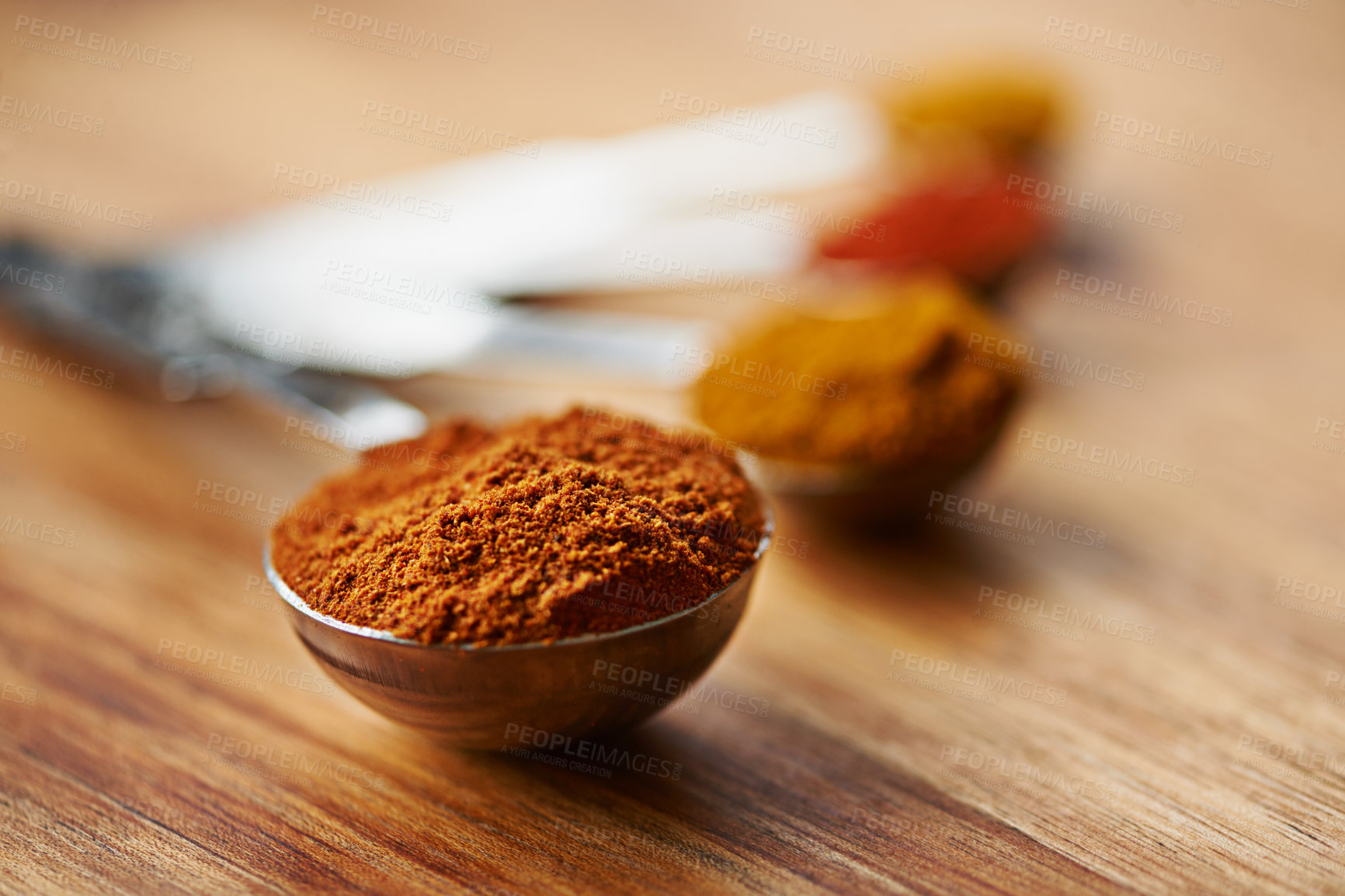 Buy stock photo Spoons, spice and selection of powder to measure on kitchen table, turmeric and paprika for meal. Top view, condiments and options for spicy cooking in Indian culture, gourmet and food preparation