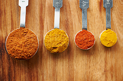 Buy stock photo Spoons, spice and selection to measure for seasoning on kitchen table, turmeric and paprika for meal. Top view, condiments and options for spicy cooking in Indian culture, nutmeg and food preparation