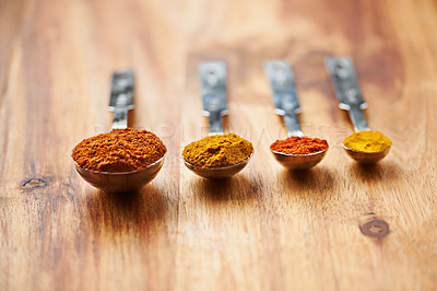 Buy stock photo Spoons, spice and collection of powder for seasoning on kitchen table, turmeric and paprika for meal. Digestion, condiments and options for cooking in Indian culture, weight loss and food preparation