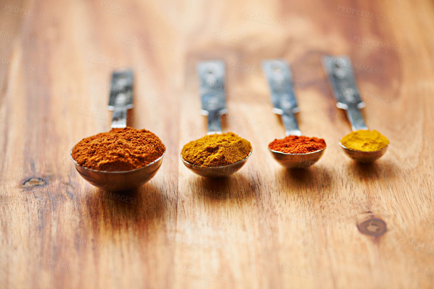 Buy stock photo Spoons, spice and collection of powder for seasoning on kitchen table, turmeric and paprika for meal. Digestion, condiments and options for cooking in Indian culture, weight loss and food preparation