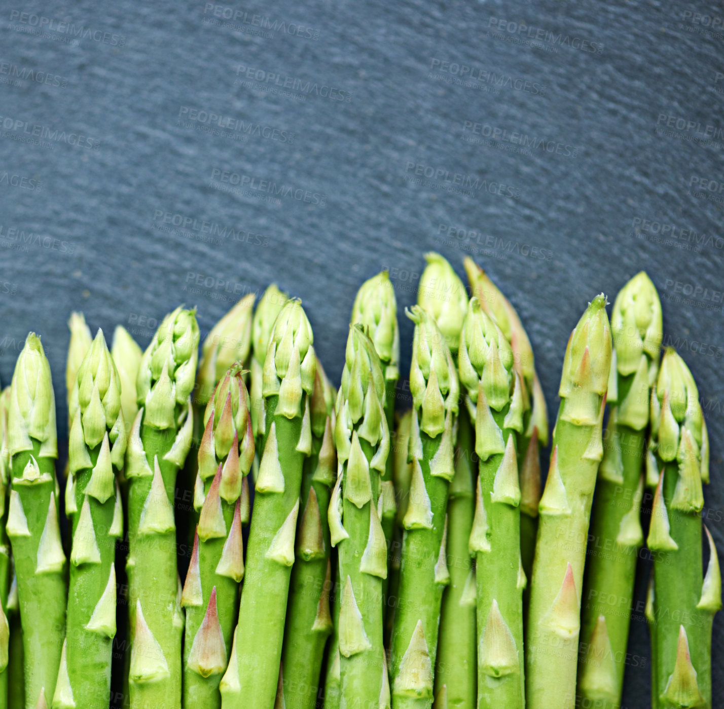 Buy stock photo Closeup, asparagus or vegetables in kitchen for food or meal prep for salad, green ingredients or dinner. Home, background or catering with healthy nutrition for vegan diet, lunch or organic produce 