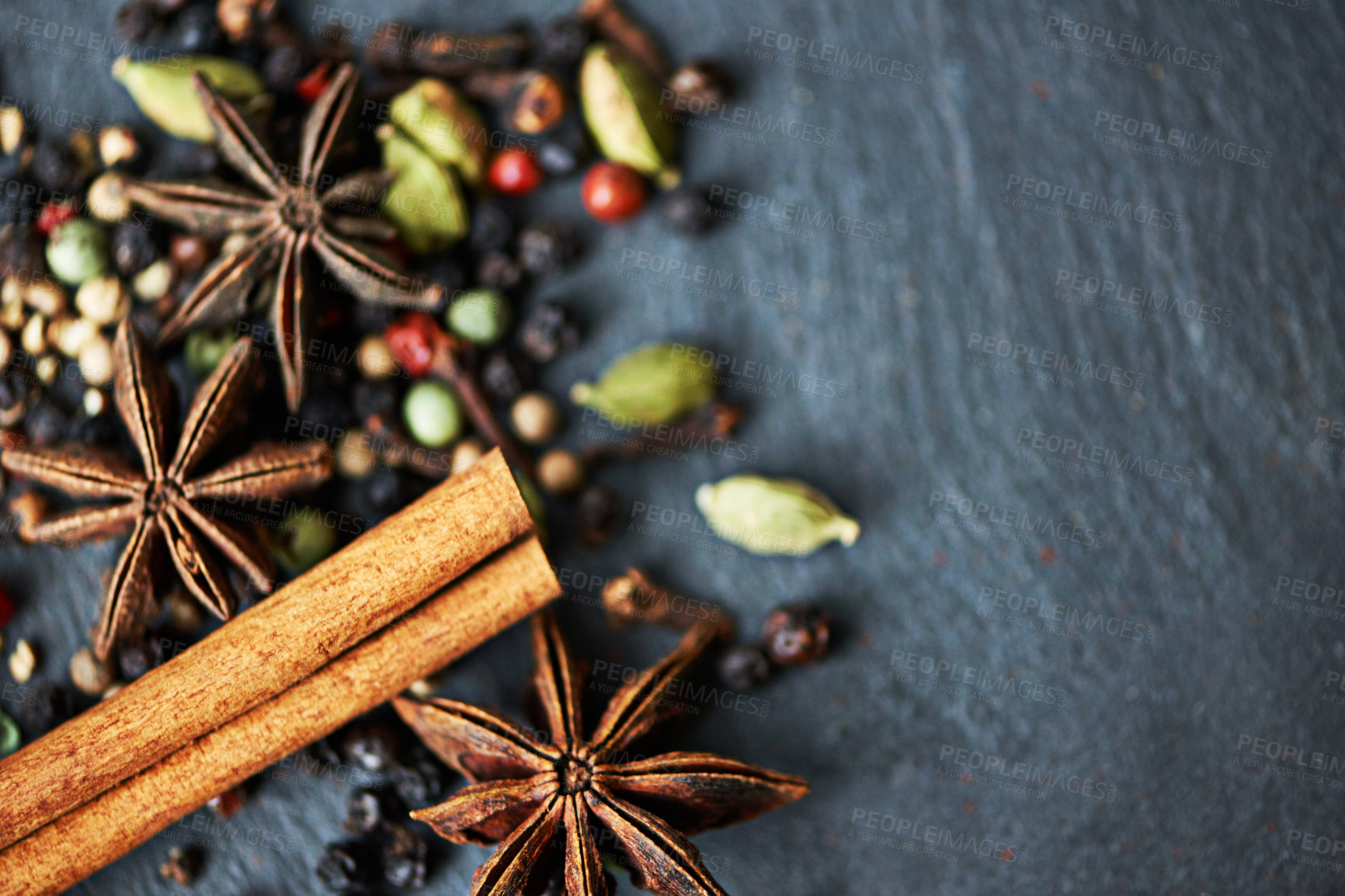 Buy stock photo Whole spices, ingredients and cooking for food with mockup, fragrance and flavor with culinary space. Stick cinnamon, star anise and peppercorn with cardamom mix for catering, seasoning and aroma