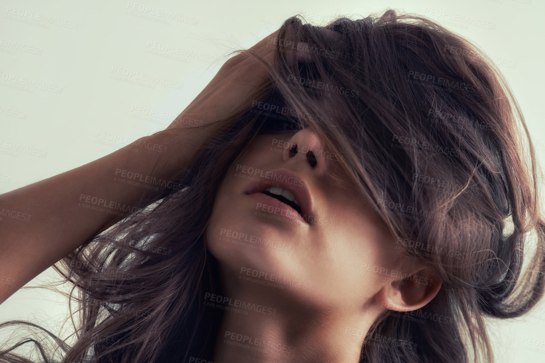 Buy stock photo Studio portrait of a gorgeous young woman posing against a grey background