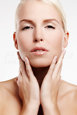 Buy stock photo Beauty shot of a young blond woman touching her face