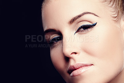 Buy stock photo Portrait of a serious woman with blue eyeliner on with black copyspace