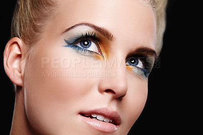 Buy stock photo Close up of a beautiful blonde woman looking up with yellow, green and blue eyeshadow