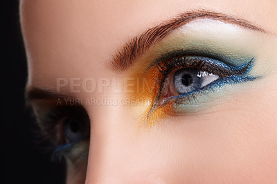 Buy stock photo Close up of a blue eye with yellow,green and blue eyeshadow