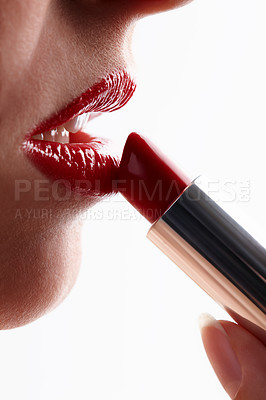 Buy stock photo Closeup shot of a woman applying vibrant red lipstick to her lips isolated on white