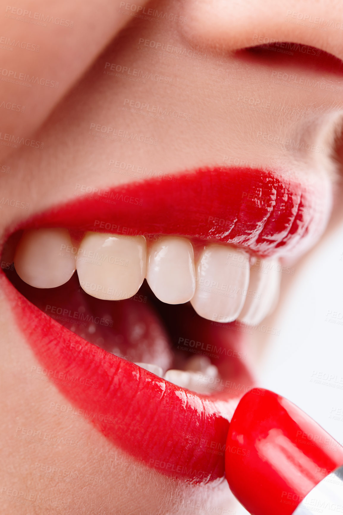 Buy stock photo Closeup shot of a woman applying vibrant red lipstick to her lips isolated on white