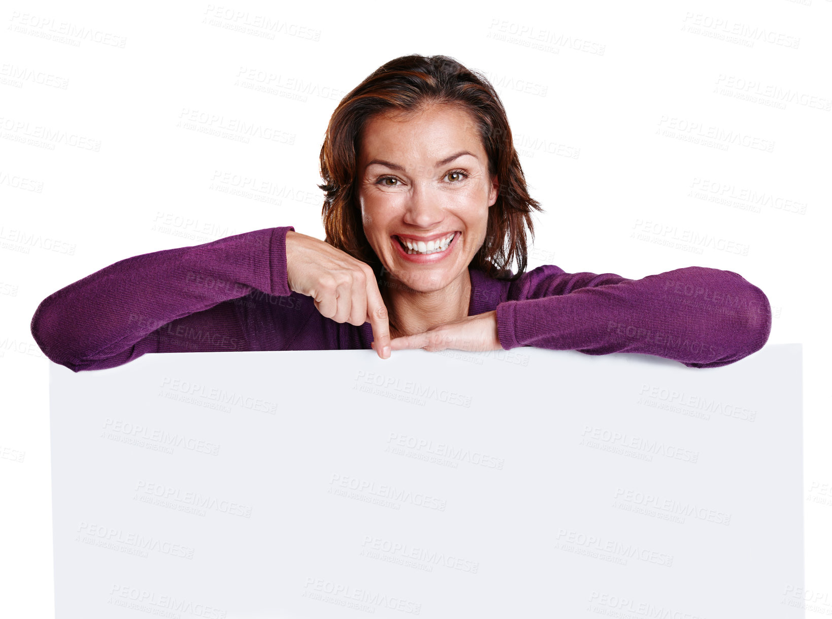 Buy stock photo Studio shot of an attractive woman in her 30's leaning on a placard while pointing and smiling at the camera