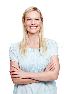 Buy stock photo A happy young woman smilng at the camera while standing with her arms folded