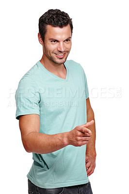 Buy stock photo Handsome man, smile and pointing finger while standing against a white studio background. Isolated attractive happy male model posing and smiling while showing direction on a white background